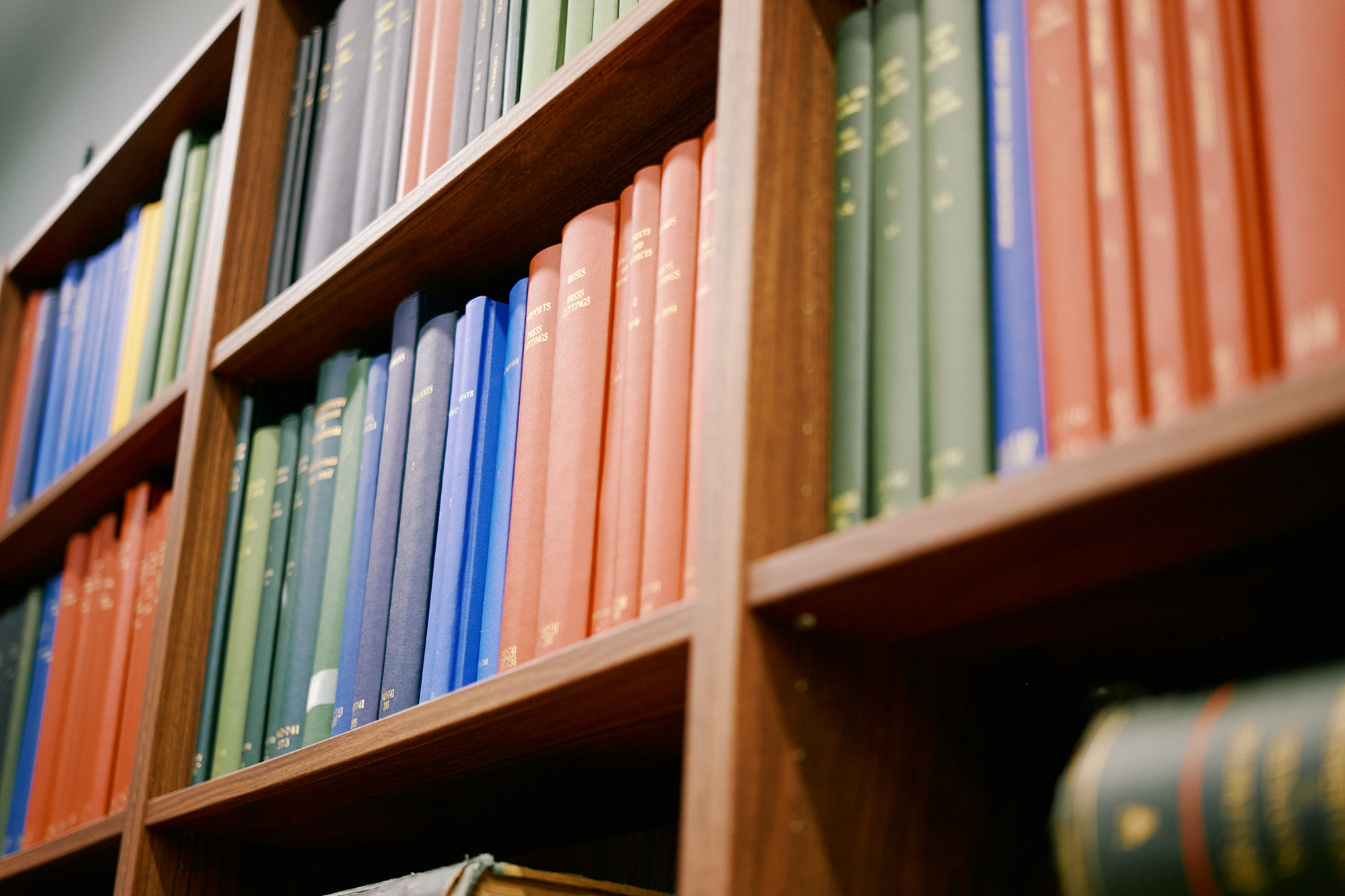 Photo of library shelving with old archives and books