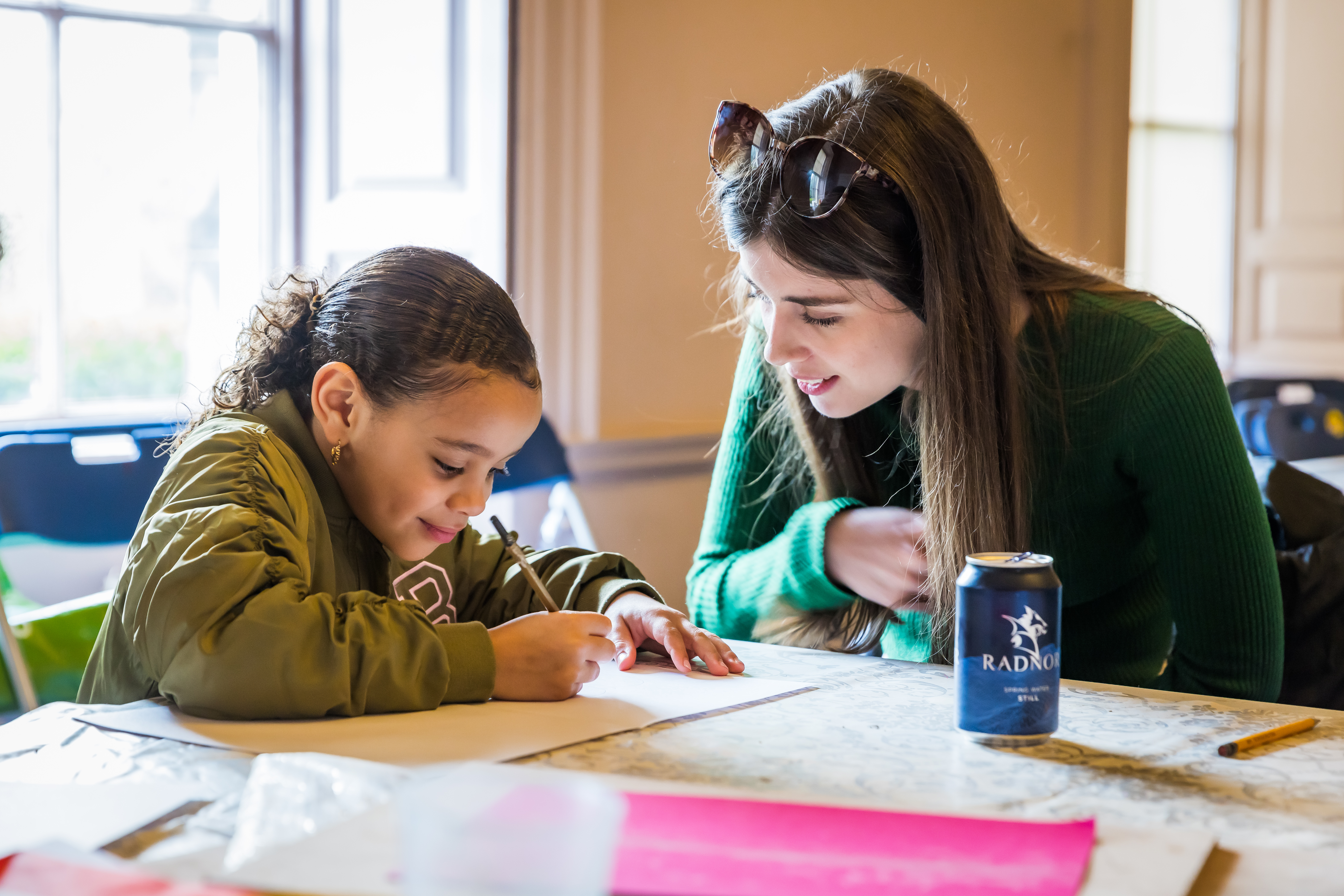 Female adult and child studying