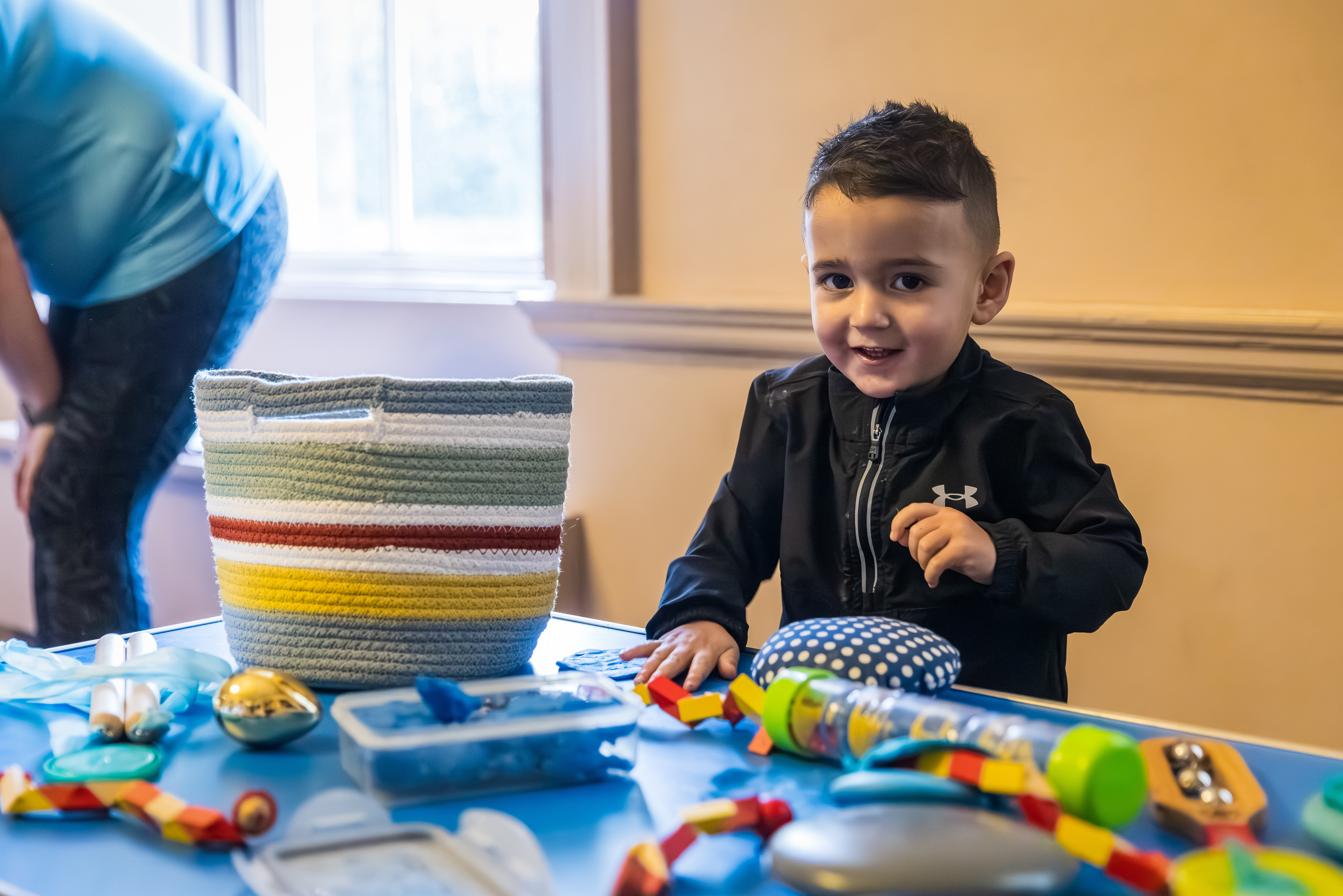 Child playing with toys at a table