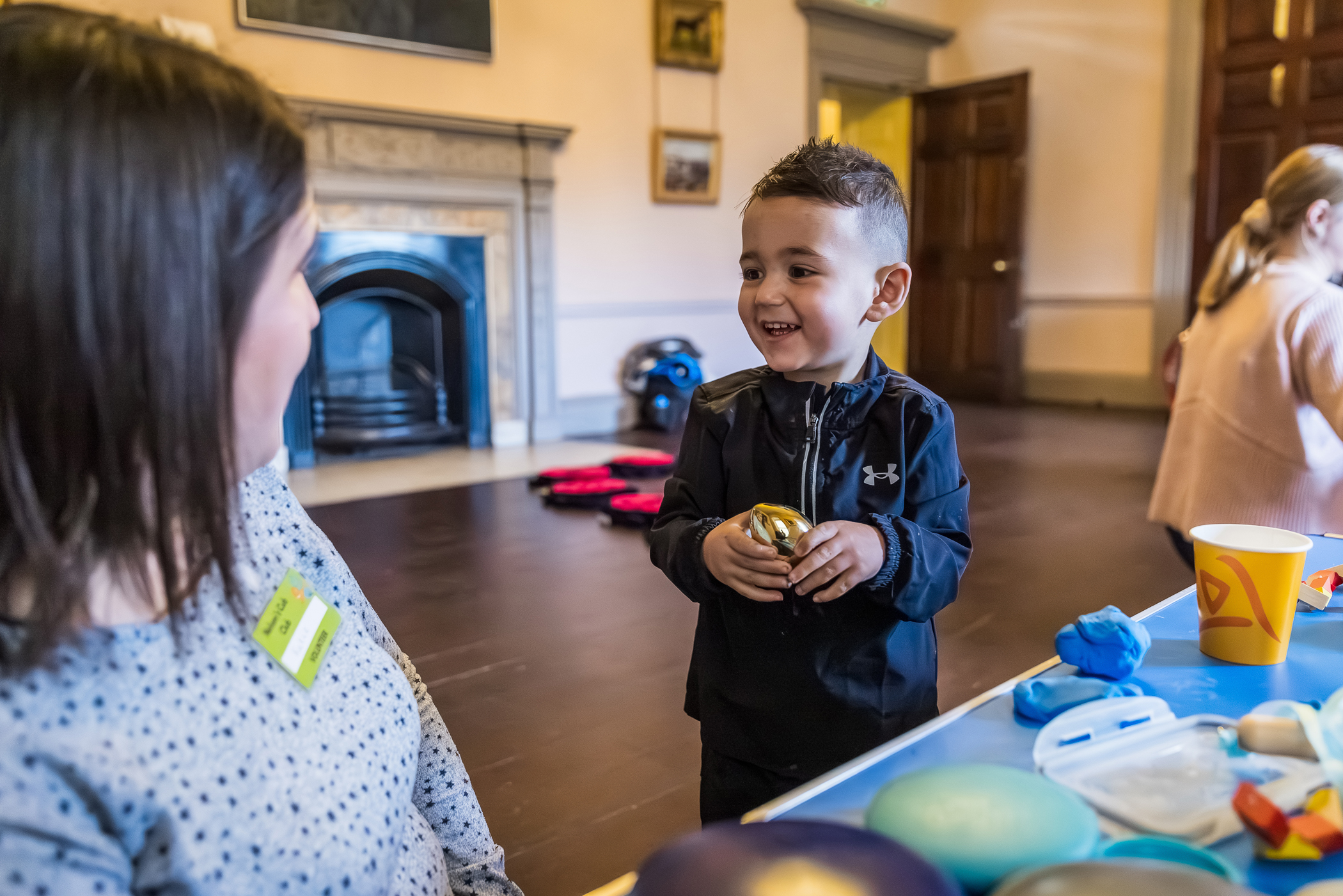 Child smiling at a Volunteer