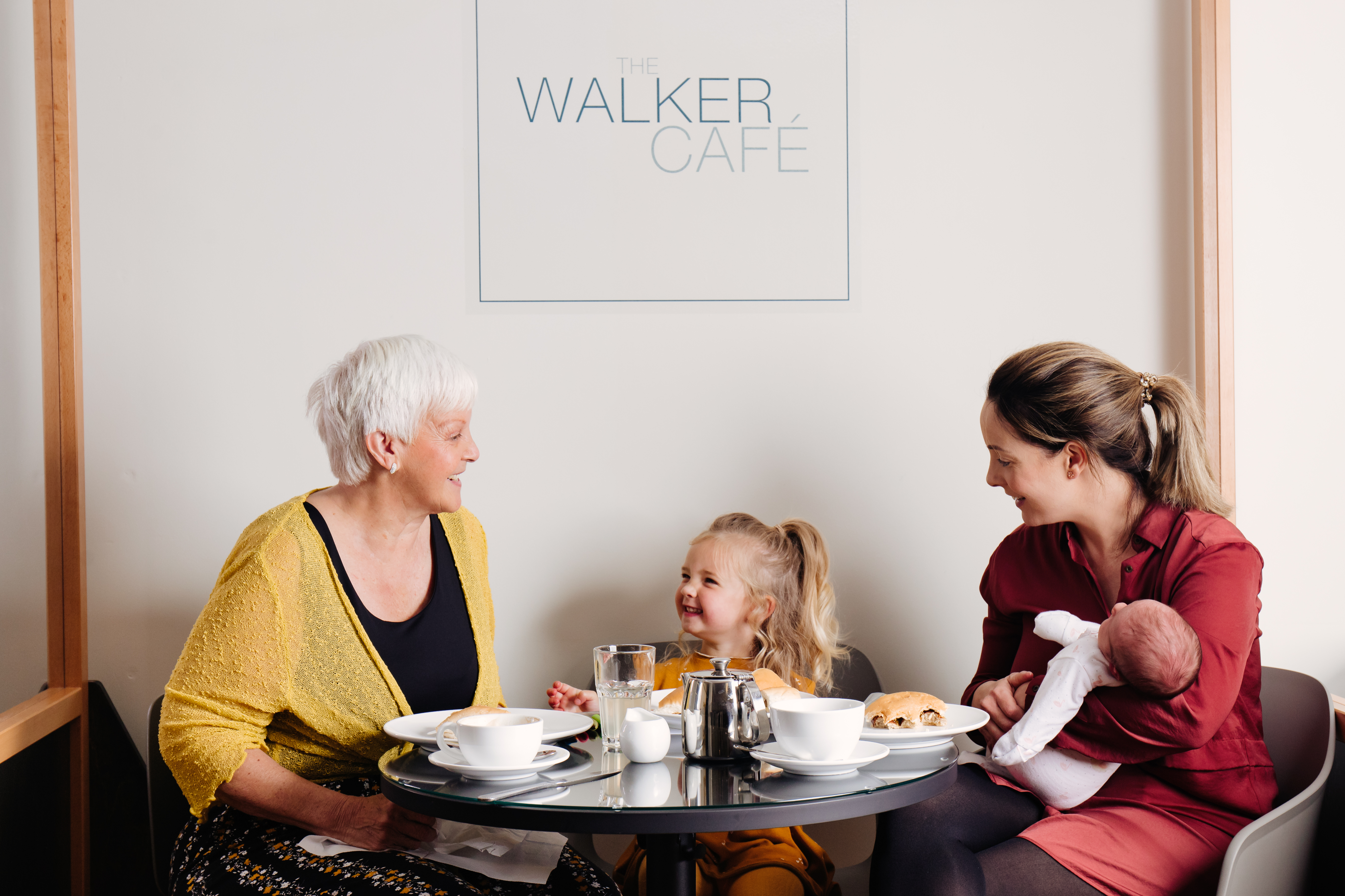 family sat inside the walker cafe and a table