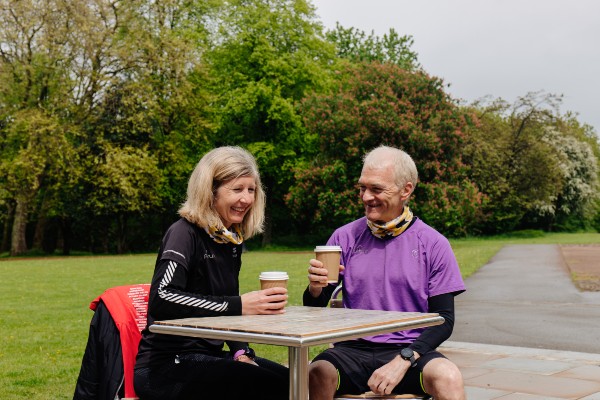 Couple enjoying drinks sat outside