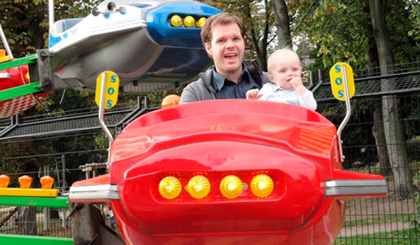 Man, and child on fairground ride